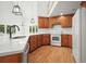 Bright kitchen with wooden cabinets, white countertops, pendant lighting, and stainless-steel appliances at 326 Seldom Seen Trl, Canton, GA 30115