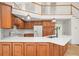 Bright kitchen with wooden cabinets, white countertops, modern appliances, and adjacent staircase at 326 Seldom Seen Trl, Canton, GA 30115