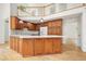 Spacious kitchen featuring wooden cabinets, granite countertops, and an island with modern pendant lighting at 326 Seldom Seen Trl, Canton, GA 30115