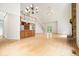 Bright living room with hardwood floors, a grand staircase, and a floor-to-ceiling stone fireplace at 326 Seldom Seen Trl, Canton, GA 30115