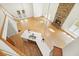 Aerial view of living room with stone fireplace, French doors, staircase, and a view of kitchen at 326 Seldom Seen Trl, Canton, GA 30115