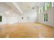 Living room area featuring light hardwood floors, high ceilings, and large windows at 326 Seldom Seen Trl, Canton, GA 30115
