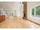 Bright, open living room with a stone fireplace, French doors leading to an outdoor pool, and a staircase at 326 Seldom Seen Trl, Canton, GA 30115