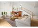Open-concept living room with high ceilings, a staircase, hardwood floors, and a view of the kitchen area at 326 Seldom Seen Trl, Canton, GA 30115