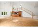 Bright, open living room featuring high ceilings, hardwood floors, staircase, and adjacent kitchen at 326 Seldom Seen Trl, Canton, GA 30115