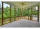 Cozy screened-in porch with wood frame and ceiling fan offering views of the private backyard at 326 Seldom Seen Trl, Canton, GA 30115