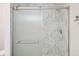 Modern bathroom with marble tile, glass shower door, and sleek fixtures at 326 Seldom Seen Trl, Canton, GA 30115