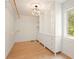 Walk-in closet with custom shelving, drawers, hanging rods and hardwood flooring at 326 Seldom Seen Trl, Canton, GA 30115