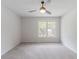 Neutral bedroom featuring plush carpeting, a ceiling fan, and a window with outside views at 19 Willowbrook Ct, Acworth, GA 30101