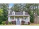 Charming home with a cozy front porch, dormer windows, and a well-maintained lawn with mature trees at 19 Willowbrook Ct, Acworth, GA 30101