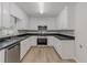Well-lit kitchen boasts stainless steel appliances, dark countertops, and white cabinetry for a modern feel at 19 Willowbrook Ct, Acworth, GA 30101