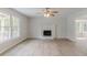 Open living area featuring hardwood floors, fireplace, and plenty of natural light from multiple windows at 19 Willowbrook Ct, Acworth, GA 30101