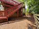 Backyard view of steps and deck, wooden fence and wooded area at 1924 Wilkenson Xing, Marietta, GA 30066