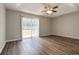 Bedroom with tray ceiling, fan and sliding glass doors with access to the back yard at 210 Riveredge Way, Mcdonough, GA 30252