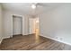 Bright bedroom features new ceiling fan, closet and wood-look flooring at 210 Riveredge Way, Mcdonough, GA 30252