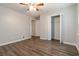 This bedroom is equipped with wood-look floors, spacious closet and a ceiling fan at 210 Riveredge Way, Mcdonough, GA 30252
