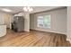 Dining space with hardwood floors, next to stainless steel refrigerator at 210 Riveredge Way, Mcdonough, GA 30252