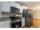 Bright kitchen with stainless steel appliances and granite countertops at 210 Riveredge Way, Mcdonough, GA 30252