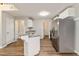 Bright kitchen with granite counters, stainless steel refrigerator and hardwood flooring at 210 Riveredge Way, Mcdonough, GA 30252