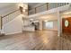Bright open-concept living space featuring a staircase and hardwood flooring at 210 Riveredge Way, Mcdonough, GA 30252