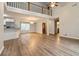 Spacious living area featuring hardwood flooring and a view of the stairs at 210 Riveredge Way, Mcdonough, GA 30252