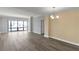 Bright, open living room with large windows showcasing cityscape views and wood flooring at 3475 Oak Valley Ne Rd # 1930, Atlanta, GA 30326