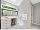 Bright vanity area features white cabinets, light gray walls and flooring and natural lighting at 3638 Sope Creek Farm Se, Marietta, GA 30067