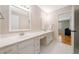 Bathroom featuring long, white vanity with double sinks and modern fixtures at 3638 Sope Creek Farm Se, Marietta, GA 30067
