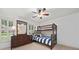 Bright bedroom with wooden bunk beds, wooden furniture and window with white shutters at 3638 Sope Creek Farm Se, Marietta, GA 30067