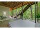Expansive outdoor deck with hot tub, staircase, and wooded views perfect for entertaining and relaxation at 3638 Sope Creek Farm Se, Marietta, GA 30067