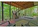 Enjoy the outdoors with this deck, featuring a hot tub and stairs leading to a lush, wooded backyard at 3638 Sope Creek Farm Se, Marietta, GA 30067