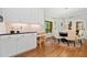 Bright dining area features hardwood floors, built in office space, large windows, and a modern light fixture at 3638 Sope Creek Farm Se, Marietta, GA 30067