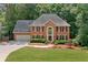 Charming two-story brick home featuring a well-manicured lawn and lush landscaping at 3638 Sope Creek Farm Se, Marietta, GA 30067