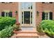 Close-up of the front entrance, showcasing the elegant door, sidelights, and decorative plants at 3638 Sope Creek Farm Se, Marietta, GA 30067