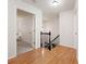 Bright hallway with hardwood floors, white walls, staircase, and an open doorway to another room at 3638 Sope Creek Farm Se, Marietta, GA 30067