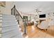 Open living room with hardwood floors, staircase, and fireplace at 3638 Sope Creek Farm Se, Marietta, GA 30067