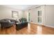 Cozy living room with hardwood floors, comfortable seating, and natural light from shuttered windows at 3638 Sope Creek Farm Se, Marietta, GA 30067