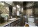 Stylish powder room with a dark vanity, unique wallpaper, decorative mirror, and modern fixtures at 3638 Sope Creek Farm Se, Marietta, GA 30067