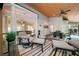 Comfortable screened-in porch with ample seating, colorful rug, string lights, and a view of nature at 3638 Sope Creek Farm Se, Marietta, GA 30067