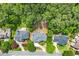 Aerial view of the house with a basketball court, a fire pit, and a well-maintained lawn at 542 Fairway Dr, Woodstock, GA 30189