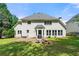 Enjoy a large backyard, patio, and fire pit featured beside the home's exterior at 542 Fairway Dr, Woodstock, GA 30189