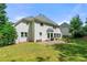 Large backyard provides ample space for outdoor enjoyment, featuring a patio, fire pit, and lawn at 542 Fairway Dr, Woodstock, GA 30189