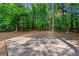 Backyard basketball court and mature trees offer recreation and privacy at 542 Fairway Dr, Woodstock, GA 30189