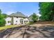 Extensive backyard has a basketball court, a paved patio and a grassy area at 542 Fairway Dr, Woodstock, GA 30189