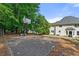 Enjoy outdoor activities on the backyard basketball court beside a lovely patio and house exterior at 542 Fairway Dr, Woodstock, GA 30189