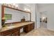 Bathroom featuring granite counters, dual sinks and a large framed mirror at 542 Fairway Dr, Woodstock, GA 30189