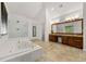 Bright bathroom features a soaking tub and separate glass-enclosed shower at 542 Fairway Dr, Woodstock, GA 30189