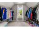 Walk-in closet with hanging racks and shelving for ample storage space at 542 Fairway Dr, Woodstock, GA 30189