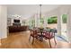 Bright dining area features a round table and view of backyard's mature trees at 542 Fairway Dr, Woodstock, GA 30189