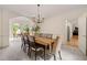 Open-concept dining room with modern chandelier, seamlessly flowing into living area for easy entertaining at 542 Fairway Dr, Woodstock, GA 30189